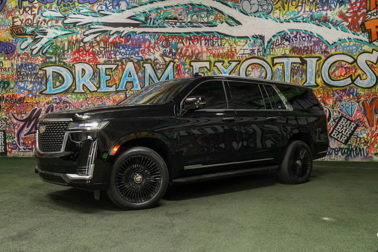 Front side view of black Cadillac Escalade ESV at Dream Exotics