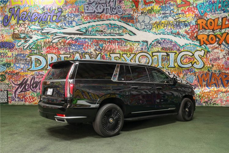 Rear side view of black Cadillac Escalade ESV