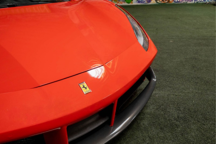 Ferrari badge on red Ferrari 488 Spider rental