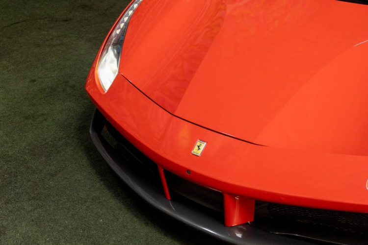 Close-up of red Ferrari 488 Spider front end and hood