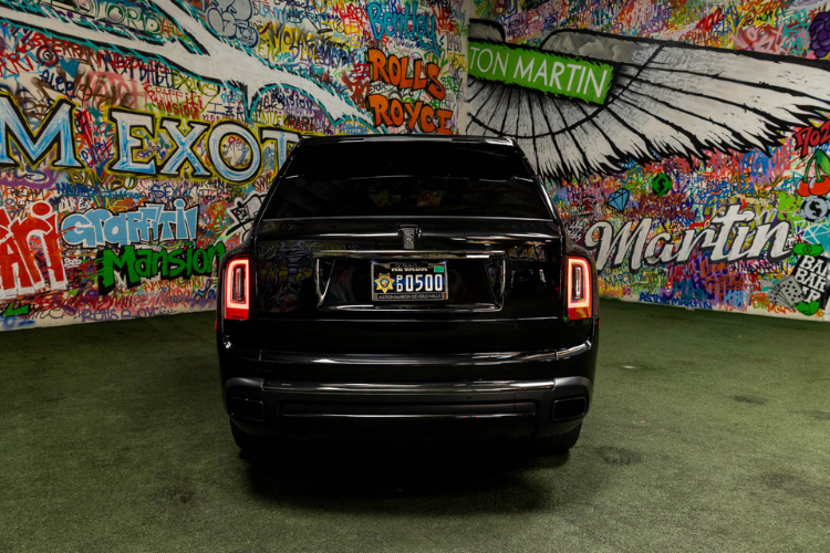 Rear view of a black Rolls-Royce Cullinan rental at Dream Exotics