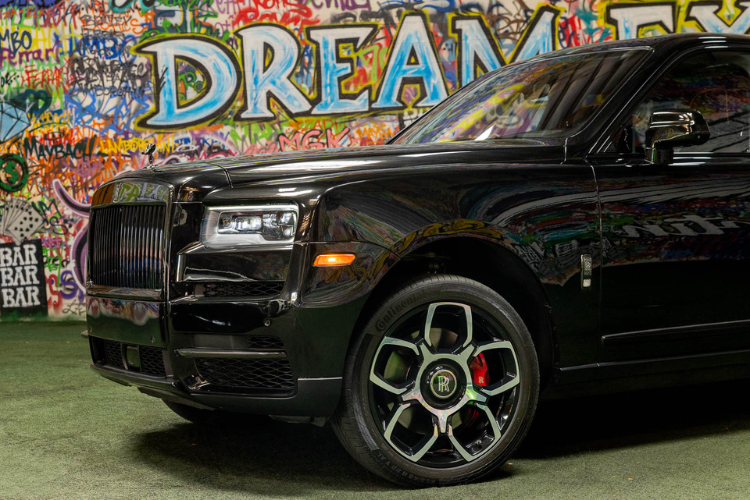 Front wheel and side view of a black Rolls-Royce Cullinan rental in Los Angeles