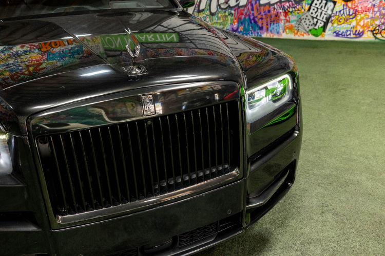 Front wheel and side view of a black Rolls-Royce Cullinan rental in Los Angeles