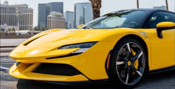 Yellow luxury sports car with Las Vegas Strip background.