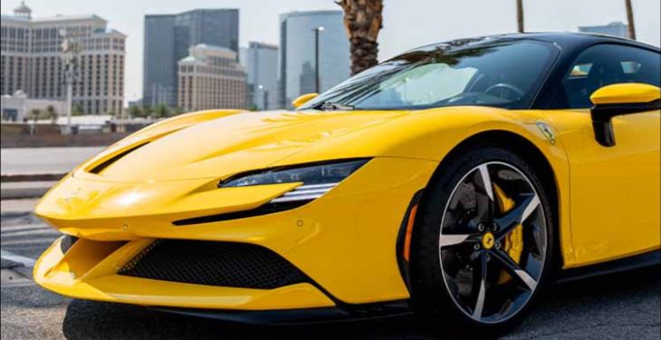 Yellow luxury sports car with Las Vegas Strip background.