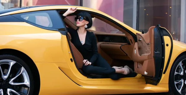 Yellow exotic wports car with fashionable woman inside.